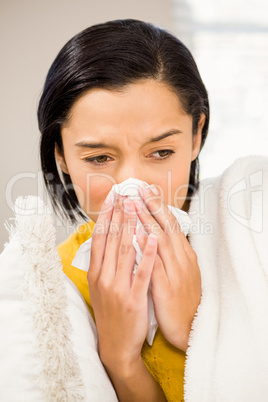 Attractive brunette sneezing