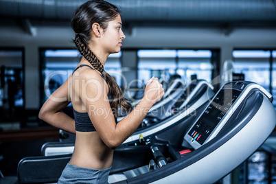 Fit woman jogging on treadmill