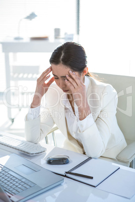 Stressed businesswoman working at her desk