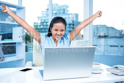 Celebrating woman with arms raised