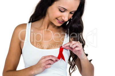 Smiling woman adjusting red ribbon