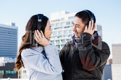 Happy couples wearing headphones