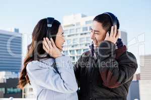 Happy couples wearing headphones