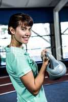 Portrait of woman holding kettlebell