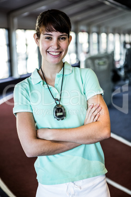 Smiling trainer with arms crossed