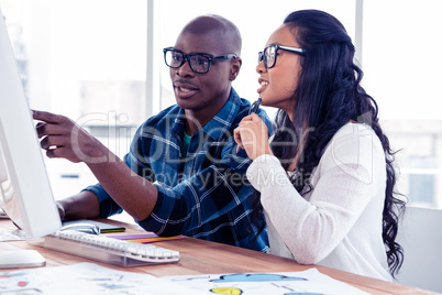 Business people discussing over computer