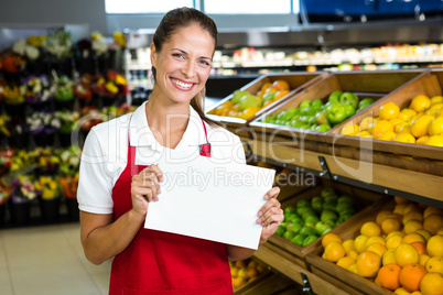 Smiling worker holding blank sign