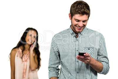 Smiling couple using smartphone