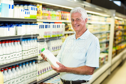 Senior man buying milk