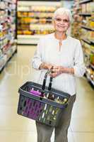 Smiling senior woman with basket