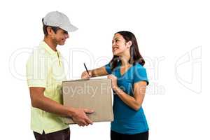 Smiling woman with delivery man holding cardboard box