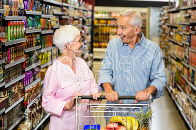 Senior couple shopping in grocery store