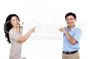 Smiling couple holding up a large sign