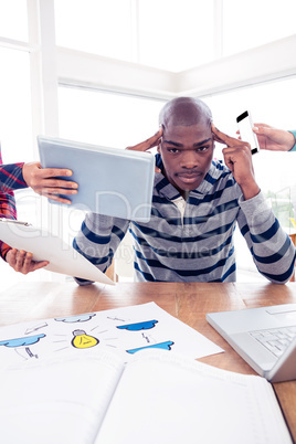 Portrait of frustrated businessman with head in hands