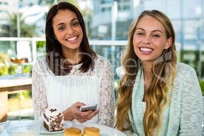 two girls watch use phone