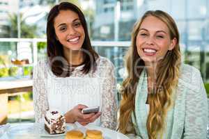 two girls watch use phone