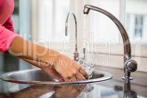 Close up of woman washing glass