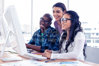 Happy business people working on computer