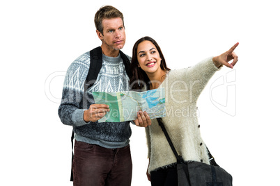 Woman traveling with boyfriend pointing while holding map