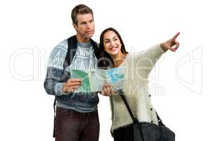 Woman traveling with boyfriend pointing while holding map