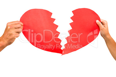 Cropped couple hands holding red cracked heart shape