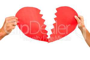 Cropped couple hands holding red cracked heart shape
