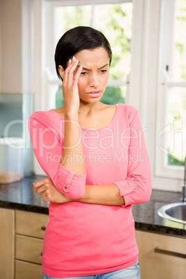 Frowning brunette with hands on face