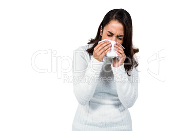 Woman sneezing while standing