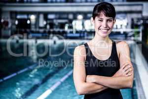 Smiling swimmer woman with arms crossed