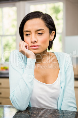 Upset brunette with hand on chin