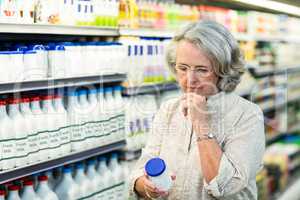 Senior woman buying milk