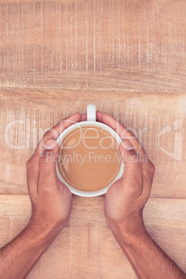 Directly above view of businessman hand holding coffee