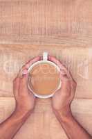 Directly above view of businessman hand holding coffee