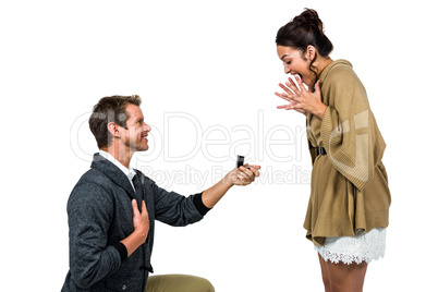 Happy man offering engagement ring to partner