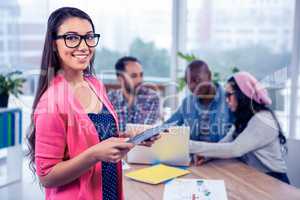 Portrait of happy young businesswoman using digital tablet