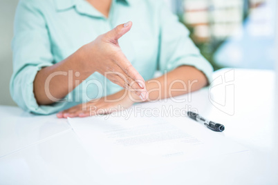 Mid section of a businesswoman ready to shake hand