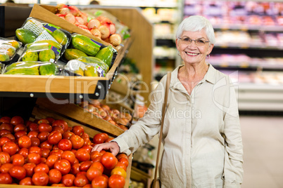 Senior woman choosing her tomatoes