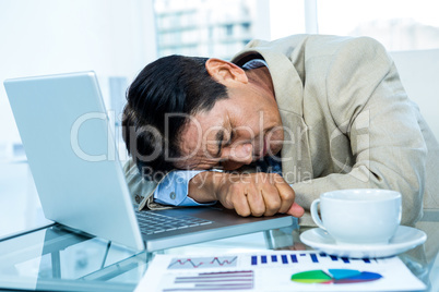 Tired asian businessman sleeping