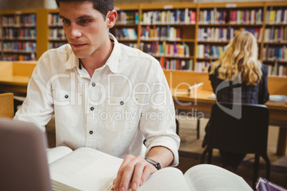 Focused student using his laptop while working