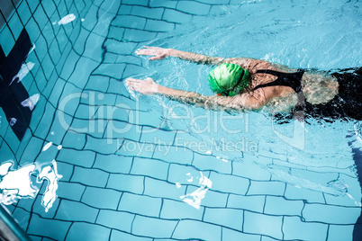 Fit woman swimming with swimming hat