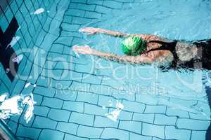 Fit woman swimming with swimming hat
