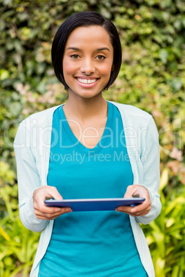 Smiling brunette using tablet