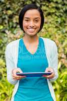 Smiling brunette using tablet