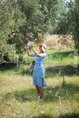 Woman taking nature shots with touch pad