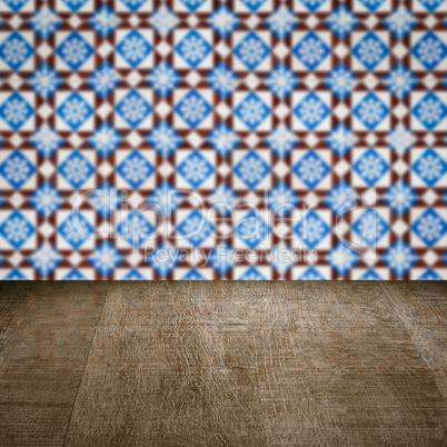 Wood table top and blur vintage ceramic tile pattern wall