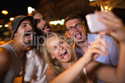 Young people taking crazy selfie with mobile