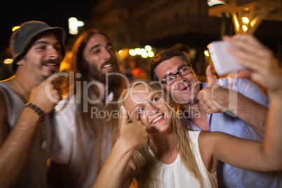Happy selfie of friends at night