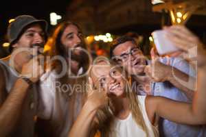 Happy selfie of friends at night