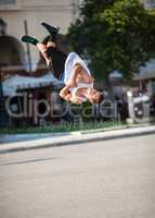 Man doing acrobatic tricks in city street