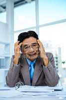 Worried businessman working at his desk